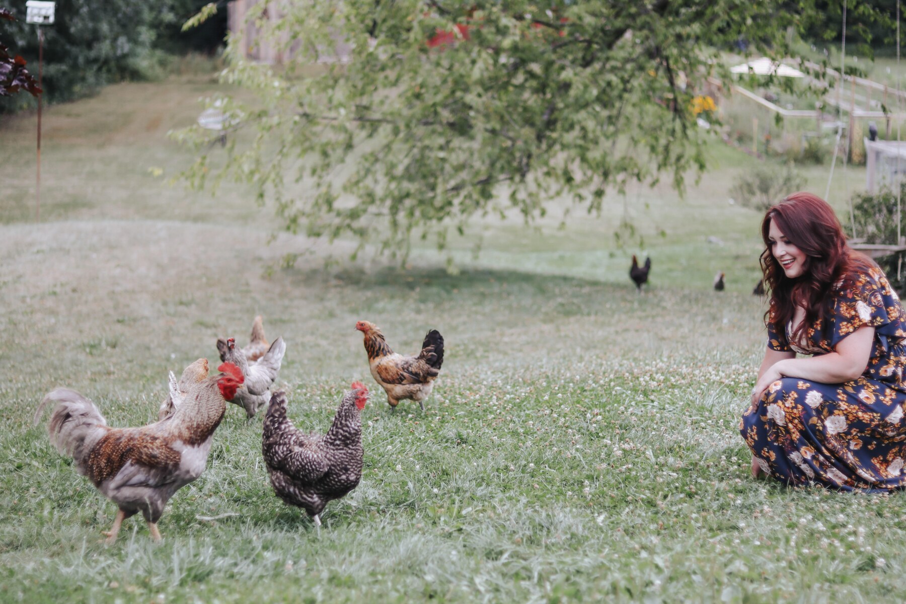Meagan smiling with chickens on her South Lyon hobby farm